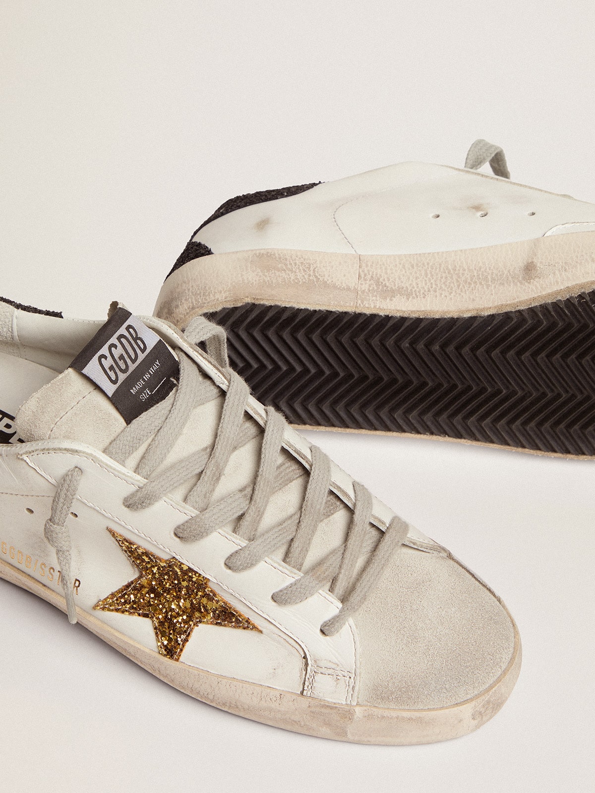 LTD con stella dorata e talloncino nero in glitter