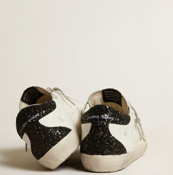 Stella oro e talloncino in glitter nero