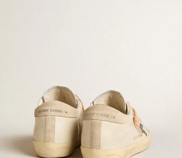 LTD in pelle con stella in suede beige con borchie Swarovski